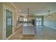 Well-lit kitchen with a blue island, stainless steel appliances, a pantry and an adjacent dining area with backyard view at 1131 Blackhorn St, Pahrump, NV 89048