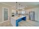 Bright, open kitchen featuring a large island with marble countertops and stainless steel appliances and a walk-in pantry at 1131 Blackhorn St, Pahrump, NV 89048