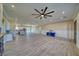 Open-concept living room featuring a ceiling fan, bar area, and tile flooring at 1131 Blackhorn St, Pahrump, NV 89048