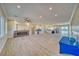 Open-concept living room featuring a stone-accented fireplace, bar area, and tile flooring at 1131 Blackhorn St, Pahrump, NV 89048