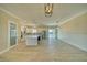 Expansive living space with a kitchen, dining, and living areas, featuring modern finishes and backyard access at 1131 Blackhorn St, Pahrump, NV 89048