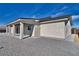 Exterior rear view featuring a covered patio with sturdy pillars and a low-maintenance gravel yard at 1131 Blackhorn St, Pahrump, NV 89048