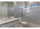 Modern bathroom with a shower, toilet and floating vanity at 11707 Hatchling Ave, Las Vegas, NV 89138