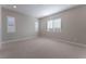 Spacious bedroom with plush carpeting and large windows with plantation shutters at 11707 Hatchling Ave, Las Vegas, NV 89138