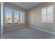 Bright bedroom with treetop views, carpet, and plantation shutters at 11707 Hatchling Ave, Las Vegas, NV 89138