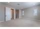Bright bedroom with neutral walls, carpeting, and an ensuite bathroom at 11707 Hatchling Ave, Las Vegas, NV 89138