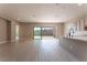 Open concept kitchen with island, modern appliances, and sliding glass doors to backyard at 11707 Hatchling Ave, Las Vegas, NV 89138