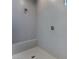 Large walk-in shower with built-in seat and wave patterned tile at 11707 Hatchling Ave, Las Vegas, NV 89138