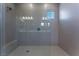 Spacious walk-in shower with glass enclosure and modern wave tile at 11707 Hatchling Ave, Las Vegas, NV 89138