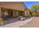 Covered patio with brick pavers, seating area, and mature plants at 1359 Skylight Way, Mesquite, NV 89034