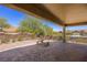 Covered patio with brick pavers, seating area, and desert landscaping at 1359 Skylight Way, Mesquite, NV 89034