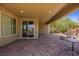 Covered patio with brick pavers, sliding glass door access, and desert landscaping at 1359 Skylight Way, Mesquite, NV 89034