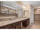 Double vanity bathroom with granite countertops and a walk-in shower at 1359 Skylight Way, Mesquite, NV 89034