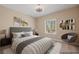Virtually staged bedroom with a queen bed, side tables, and artwork at 1359 Skylight Way, Mesquite, NV 89034