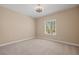 Simple bedroom with neutral walls, carpet flooring, and a ceiling fan at 1359 Skylight Way, Mesquite, NV 89034