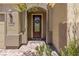 Elegant front door with a stained wood frame and glass insert at 1359 Skylight Way, Mesquite, NV 89034