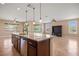 Open kitchen island with granite countertop and seating at 1359 Skylight Way, Mesquite, NV 89034
