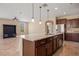 Open kitchen island with granite countertop and seating at 1359 Skylight Way, Mesquite, NV 89034