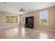 Bright living room with tile flooring, large windows, and ceiling fan at 1359 Skylight Way, Mesquite, NV 89034
