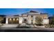 Modern home with light stone exterior, three-car garage, and landscaped front yard at 149 Tre Pietre St, Henderson, NV 89011