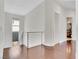 Bright hallway with hardwood floors and modern railing at 1493 Foothills Village Dr, Henderson, NV 89012