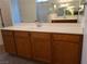 Bathroom with double sink and wood cabinets at 1706 Pondering Ave, North Las Vegas, NV 89031