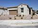 Single-story home with a two-car garage and landscaped front yard at 1706 Pondering Ave, North Las Vegas, NV 89031