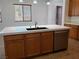 Kitchen island with white countertop and stainless steel dishwasher at 1706 Pondering Ave, North Las Vegas, NV 89031