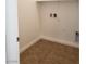Bright laundry room with tile floor and built-in shelving at 1706 Pondering Ave, North Las Vegas, NV 89031