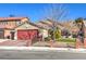 House exterior with red garage door and landscaping at 1806 Hollyberry Ct, Las Vegas, NV 89142