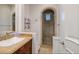 Bathroom with a walk-in shower, wood vanity, and neutral tile at 2 Yorkridge Ct, Henderson, NV 89052
