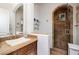 Bathroom with a large walk-in shower, wood vanity, and neutral tile at 2 Yorkridge Ct, Henderson, NV 89052