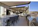 Entertaining outdoor kitchen, granite counters, and seating area at 2 Yorkridge Ct, Henderson, NV 89052