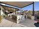Spacious outdoor kitchen with granite countertop and built-in grill at 2 Yorkridge Ct, Henderson, NV 89052