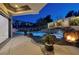 Inviting pool area with a rock waterfall, fire pit, and ample patio space at 2 Yorkridge Ct, Henderson, NV 89052