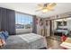 Spacious bedroom with mirrored closet doors and a ceiling fan at 2024 Shadow Brook Way, Henderson, NV 89074