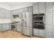 Updated kitchen, featuring stainless steel appliances and gray cabinets at 2024 Shadow Brook Way, Henderson, NV 89074