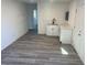 Modern white kitchen with gray vinyl plank flooring at 2036 Canosa Ave, Las Vegas, NV 89104