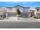 Two-story townhome with attached garage and landscaping at 2097 Audrey Hepburn St, Las Vegas, NV 89142