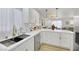 Modern kitchen with white cabinets, quartz countertops, and gold fixtures at 2097 Audrey Hepburn St, Las Vegas, NV 89142