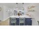 Modern kitchen with white cabinets, quartz countertops, and island seating at 2097 Audrey Hepburn St, Las Vegas, NV 89142