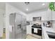 Modern kitchen with stainless steel appliances and white cabinets at 2097 Audrey Hepburn St, Las Vegas, NV 89142