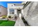 Two-story house entrance with white exterior, a walkway and landscaping at 2124 Spanish Town Ave, North Las Vegas, NV 89031