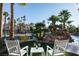 Relaxing backyard oasis with patio furniture and lake view at 2204 Glenbrook Way, Las Vegas, NV 89117