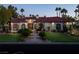 Elegant single-story home with red tile roof, landscaped lawn, and palm trees at 2204 Glenbrook Way, Las Vegas, NV 89117