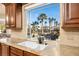 Kitchen with granite countertops, sink, and stunning pool view at 2204 Glenbrook Way, Las Vegas, NV 89117