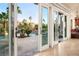 Sliding glass doors from living room open to a pool and patio area at 2204 Glenbrook Way, Las Vegas, NV 89117