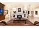 Elegant living room featuring a large stone fireplace and comfortable seating at 2204 Glenbrook Way, Las Vegas, NV 89117