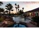 Inviting pool and spa surrounded by lush landscaping and a waterfall feature at 2204 Glenbrook Way, Las Vegas, NV 89117