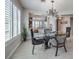 Elegant dining room with glass table and chandelier at 3 Chatmoss Rd, Henderson, NV 89052